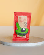 Spicy Guacamole gourmet dip mix package on a round marble slab 