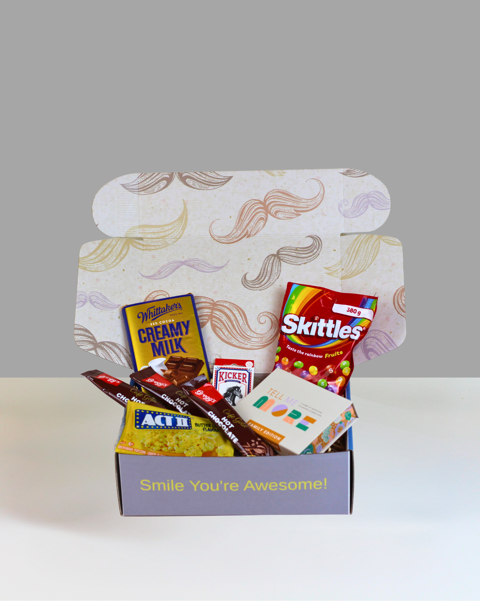 Family Games Night Gift Box with chocolate, popcorn, Skittles, playing cards, hot chocolate and Tell Me More game