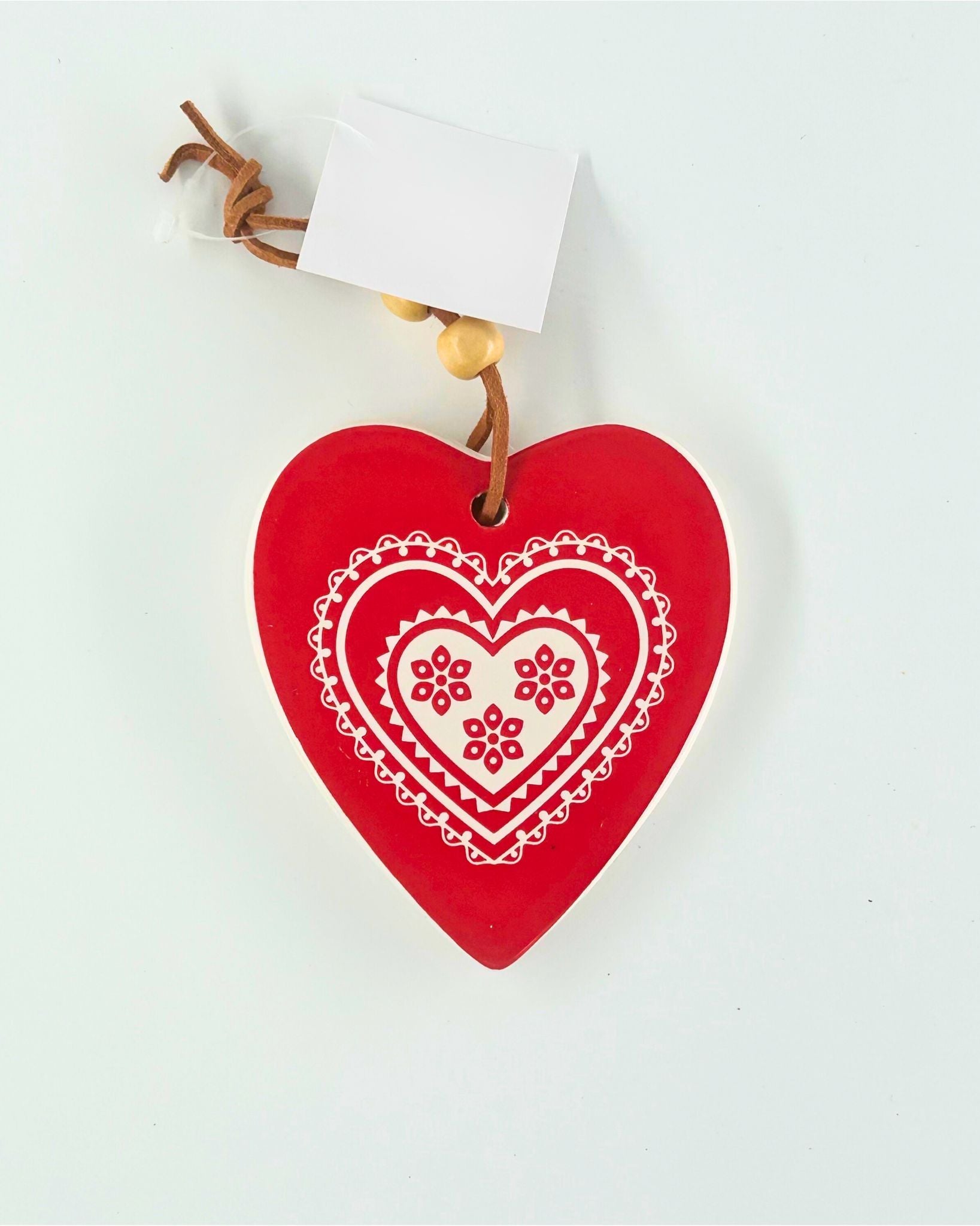 “Red ceramic heart with ‘Merry Xmas’ text — thoughtful Christmas keepsake.”