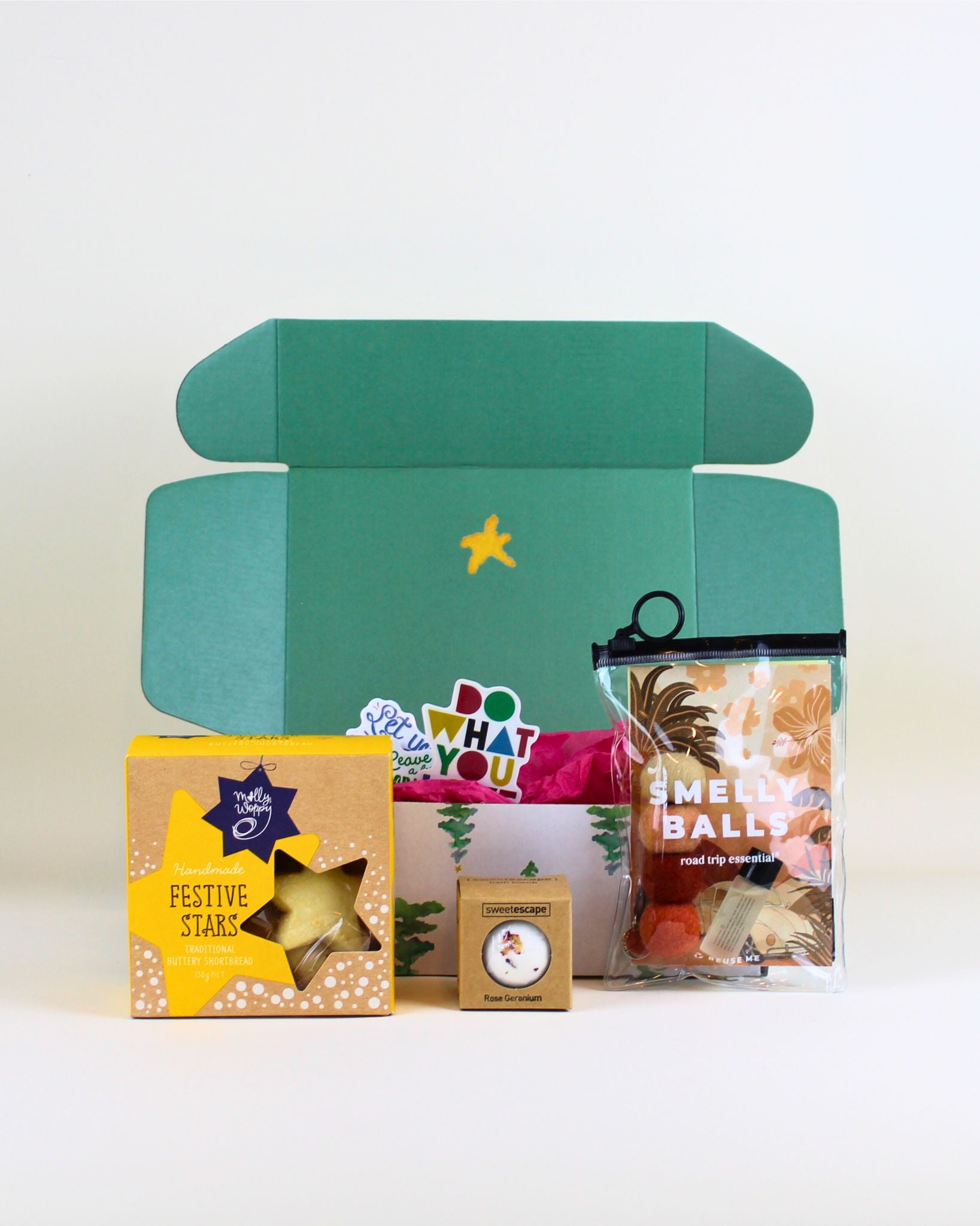 “Budget-friendly Christmas gift box with Smelly Balls air freshener, Molly Woppy cookies and Sweet Escape rose geranium bath bomb.”