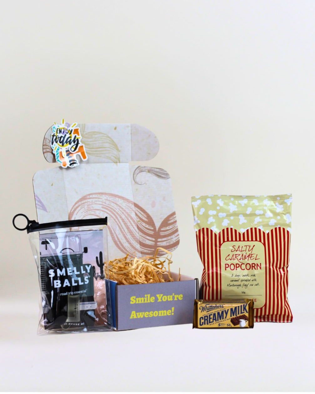 Fresh Ride Box gift box featuring a Smelly Balls car air freshener, Herb & Spice Fine Foods caramel popcorn, Whittaker's Creamy Milk Chocolate and a personalised gift card in A Box-Full signature gift box.
