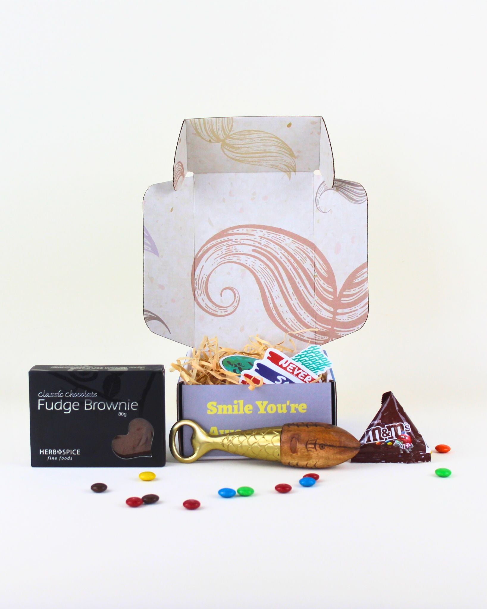 A quirky gift box for him featuring a handcrafted bottle opener muddler, brownie, M&M’s and a personalised card, presented in a fun moustache box.