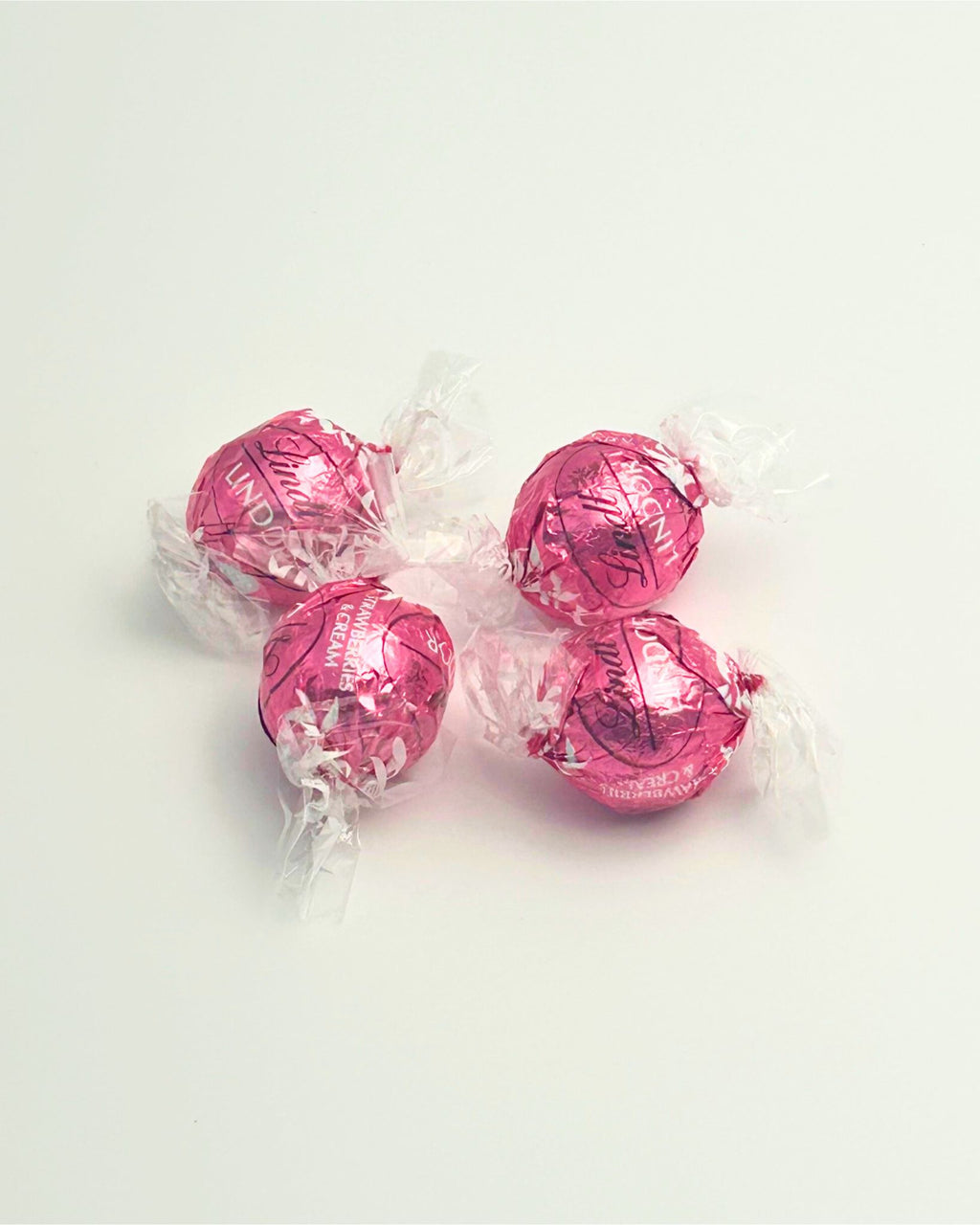 “A pack of four Lindt strawberries and cream chocolate balls, perfect as a delicious add-on for New Zealand gift boxes, hampers, or care packages.”