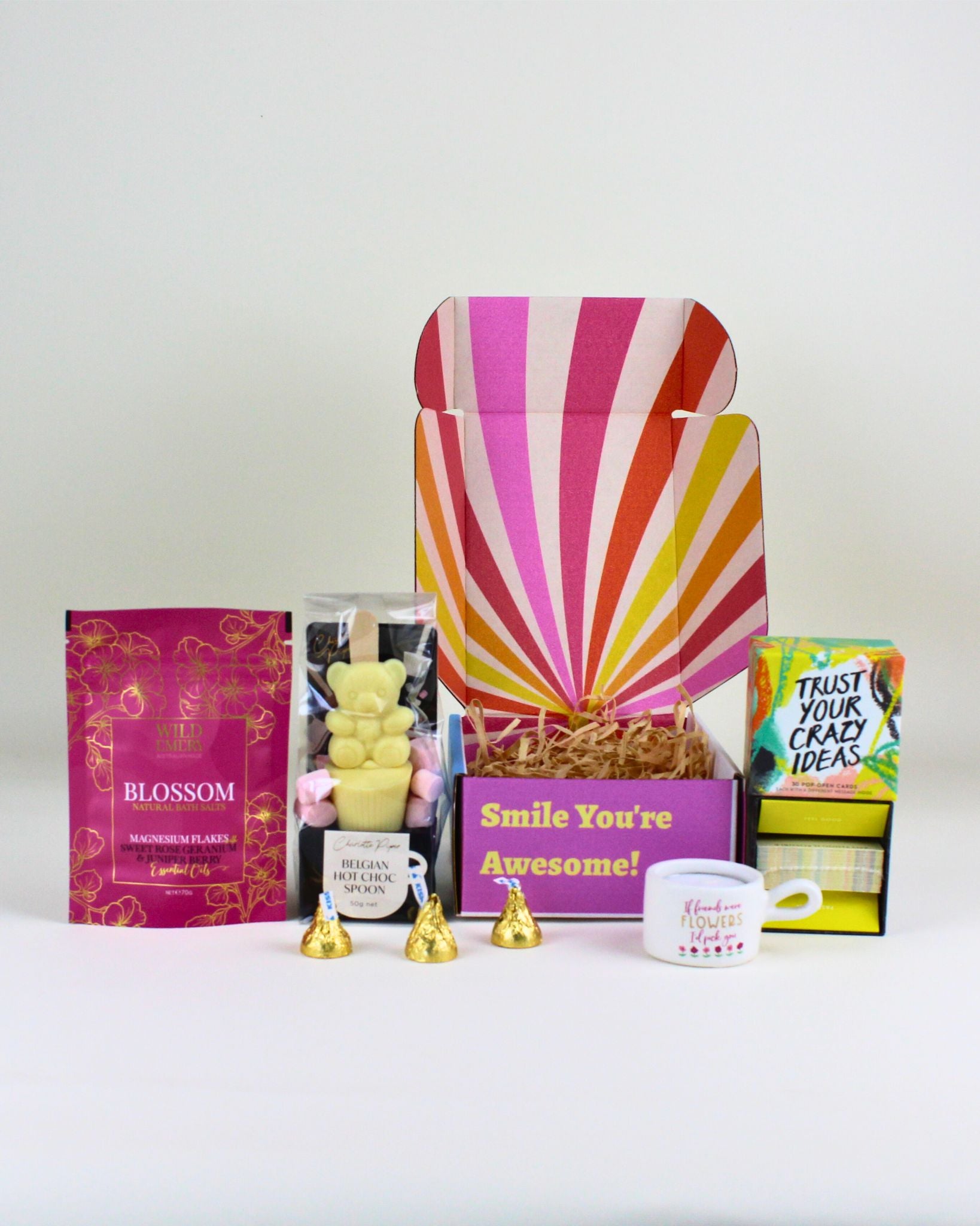 Mini friendship gift box with a friendship tealight candle, teddy bear hot chocolate spoon, trust your crazy ideas affirmations, and Wild Emery magnesium bath flakes.