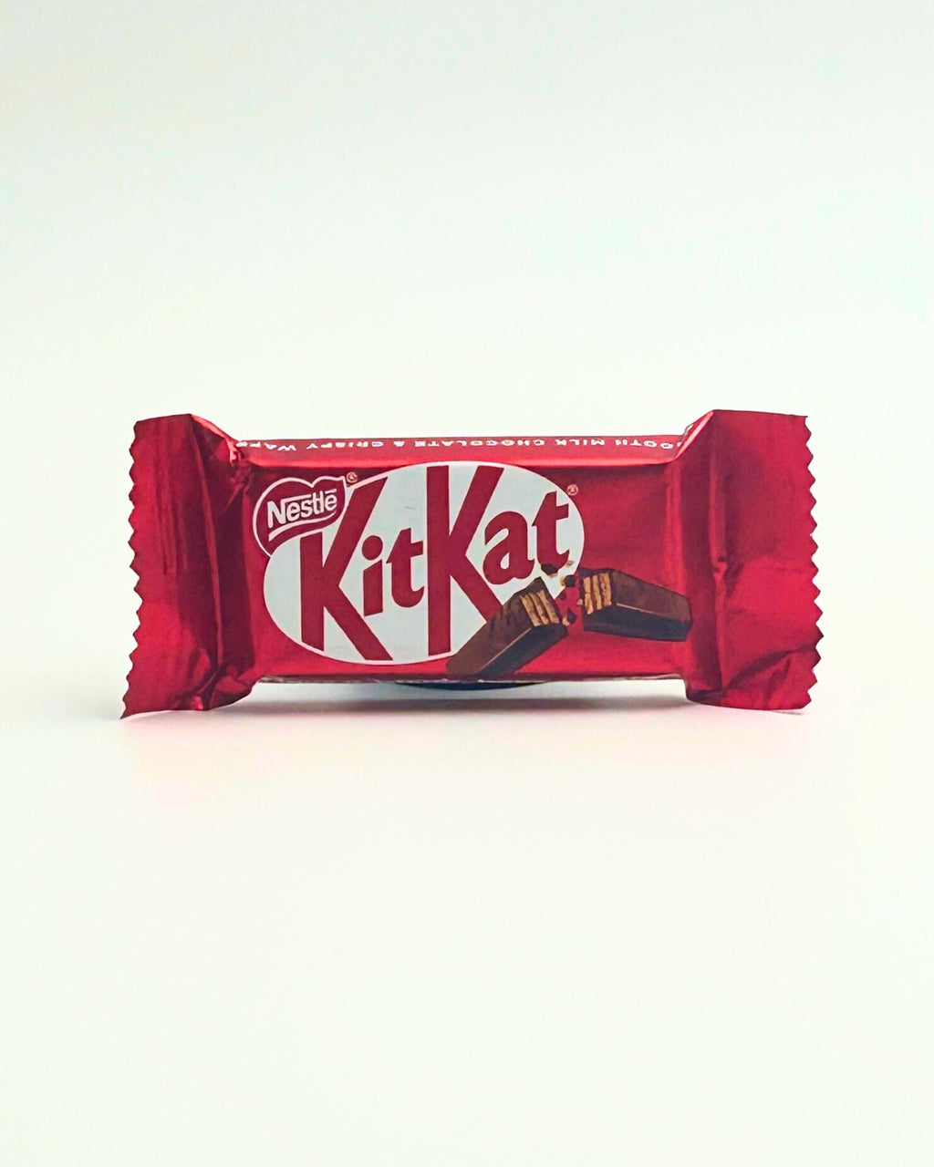 A mini Kit Kat chocolate bar, classic wafer and milk chocolate combination, ideal as a small treat, party favor, or gift box addition.