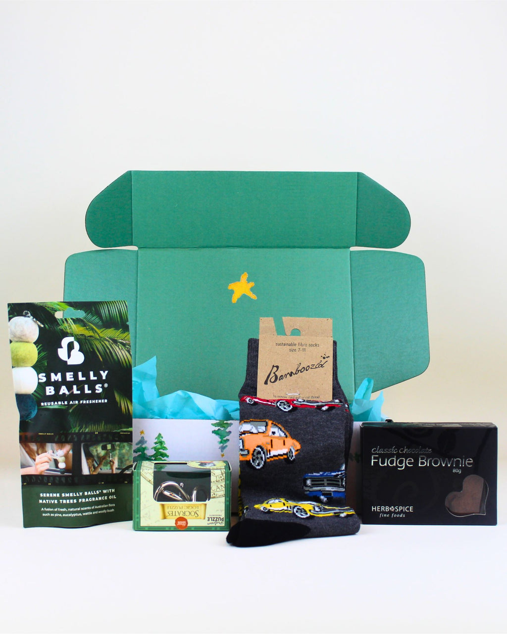 Native Gear & Goodies gift box – includes Smelly Balls car freshener, Monaro car socks, Herb & Spice fine foods chocolate brownie, and a Tinker puzzle. Perfect for gift boxes, hampers, and thoughtful wellbeing gifts NZ. Ideal for unique, fun, and practical gifting for loved ones.
