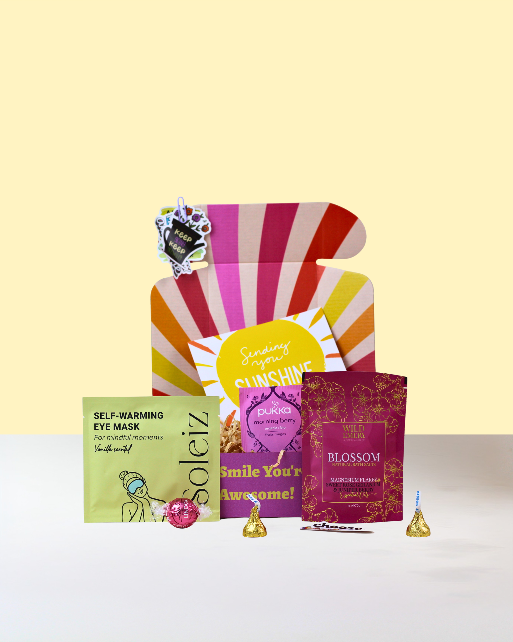 Affordable Pamper Gift Box NZ featuring Wild Emery Bath Salts, Soleiz Self-Warming Eye Mask, Pukka Tea, chocolates, affirmation cards and personalised gift card in a Smile You Are Awesome gift box.