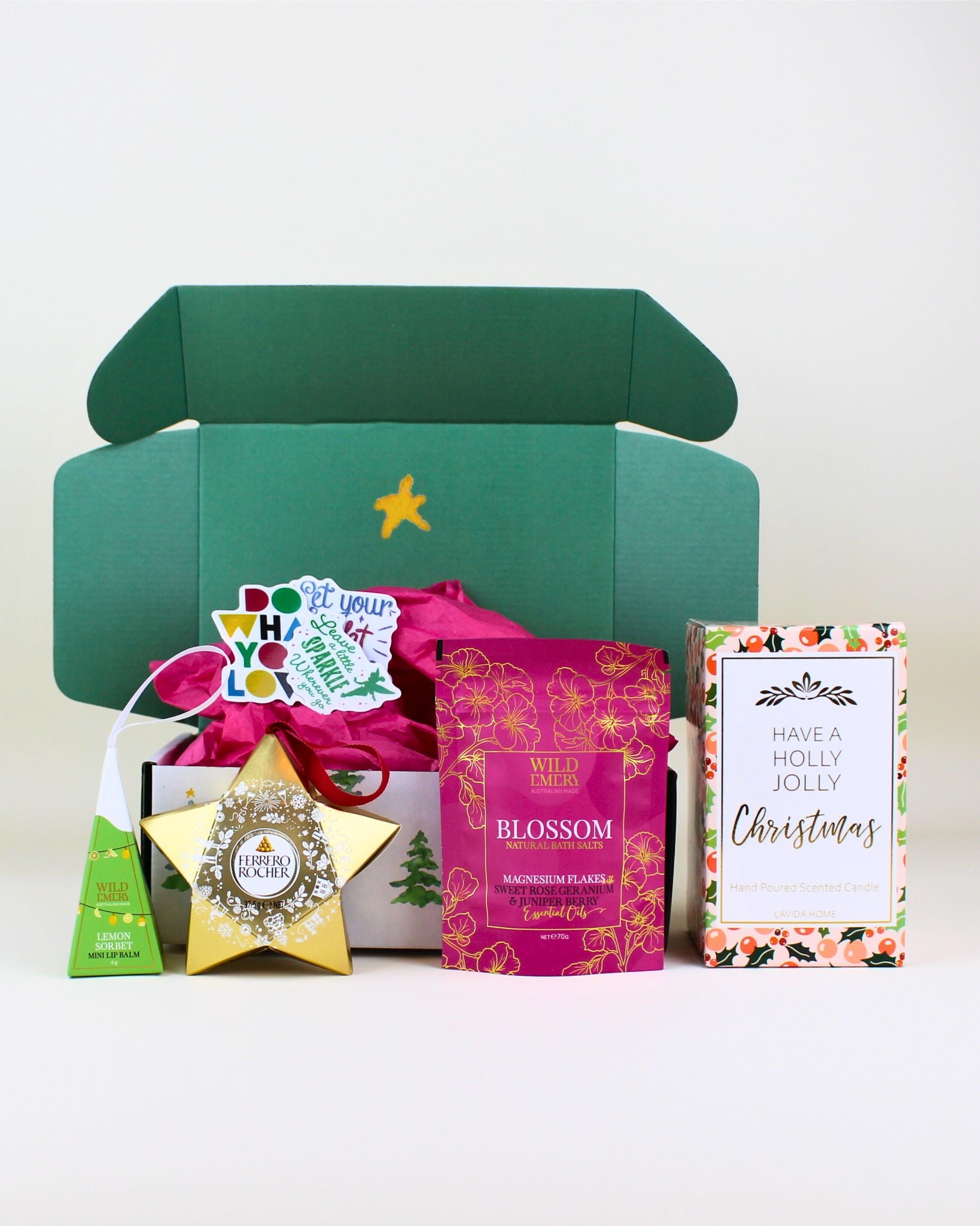 Give the gift of festive relaxation with The Christmas Serenity & Indulgence Pamper Box. This beautifully curated Christmas set includes a luxurious Holly Jolly candle, Wild Emery bath salts, a lemon sorbet lip balm, Ferrero Rocher treats, and uplifting affirmations. A perfect premium gift for Christmas self-care, pampering, and holiday joy.