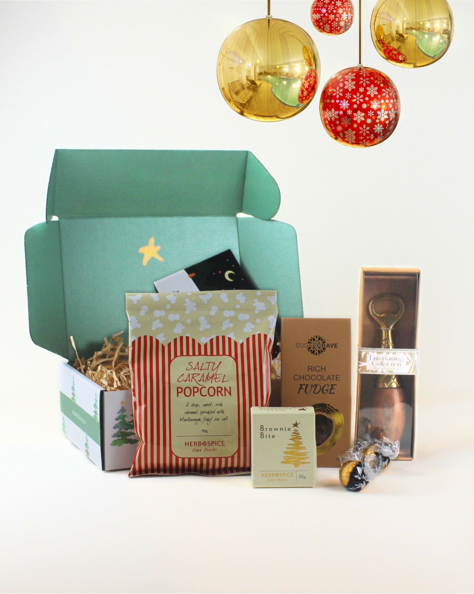 Celebrate the season with The Festive Sips & Snacks Christmas Box, featuring a wooden-handled bottle opener, citrus juicer, festive Herb & Spice treats, and a personalised gift card. A thoughtful and joyful Christmas gift for anyone.