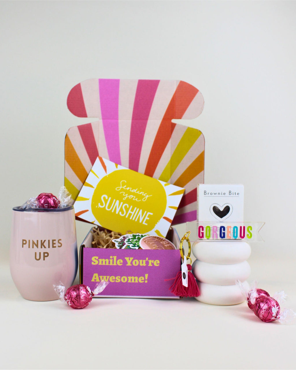 Pinkies Up wine tumbler in light pink with treats and keychain in sunshine gift box