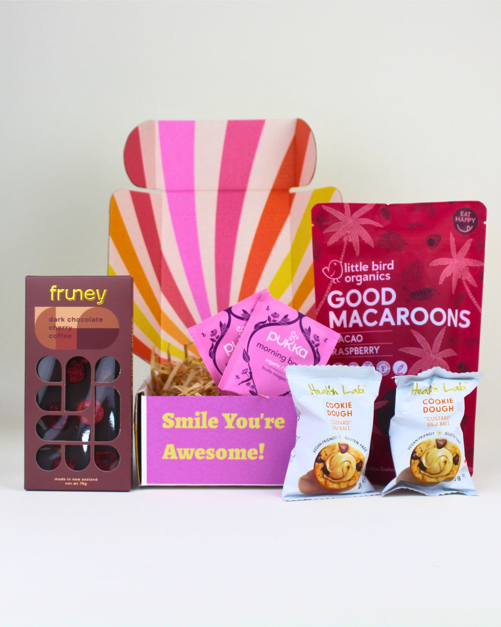 A Vegan Gift Box featuring a Fruney’s dark chocolate bar with cherry and coffee, cookie dough bliss balls, cocoa raspberry macaroons and Pukka berry tea.