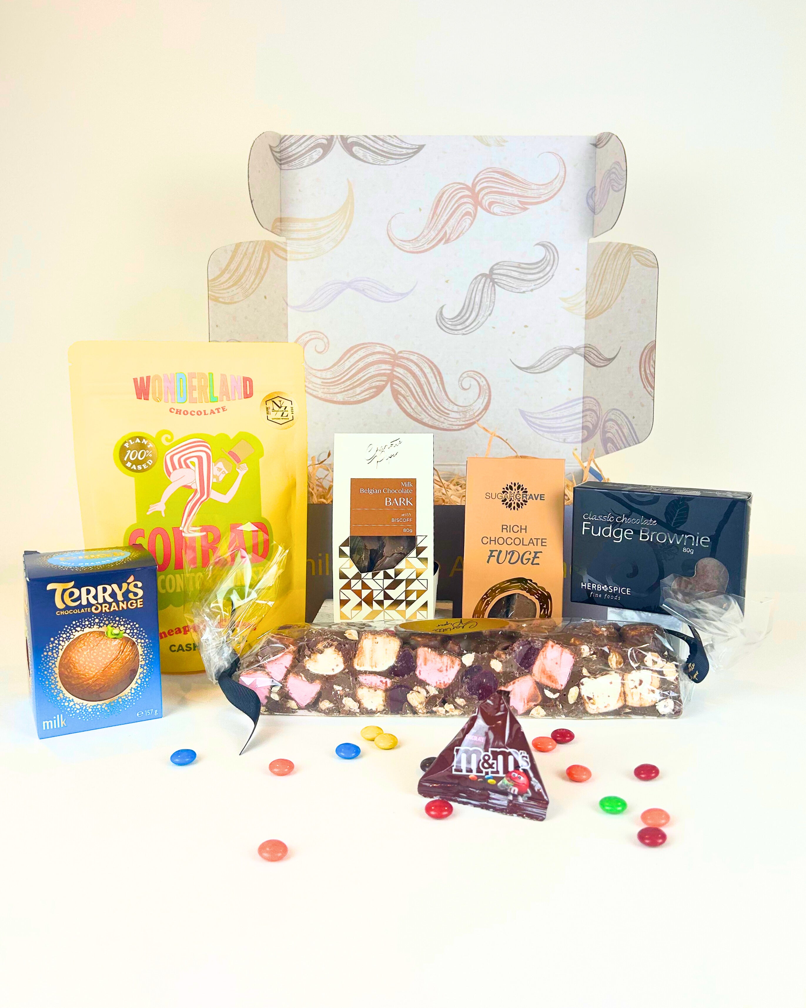 Chocolate gift box NZ – premium assortment of artisan and gourmet chocolates from Charlotte Piper, Wonderland Chocolate, Sugar Crave, Terry’s Chocolate Orange, and Herb & Spice Fine Foods, beautifully packaged for delivery across New Zealand.
